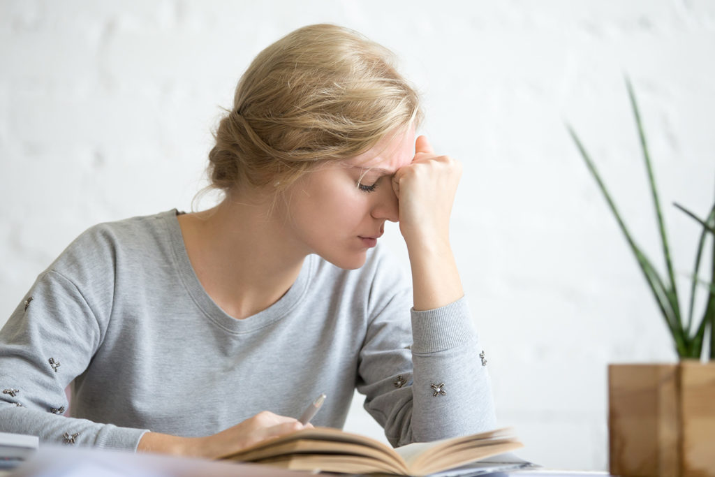 a woman suffering from vertigo while reading