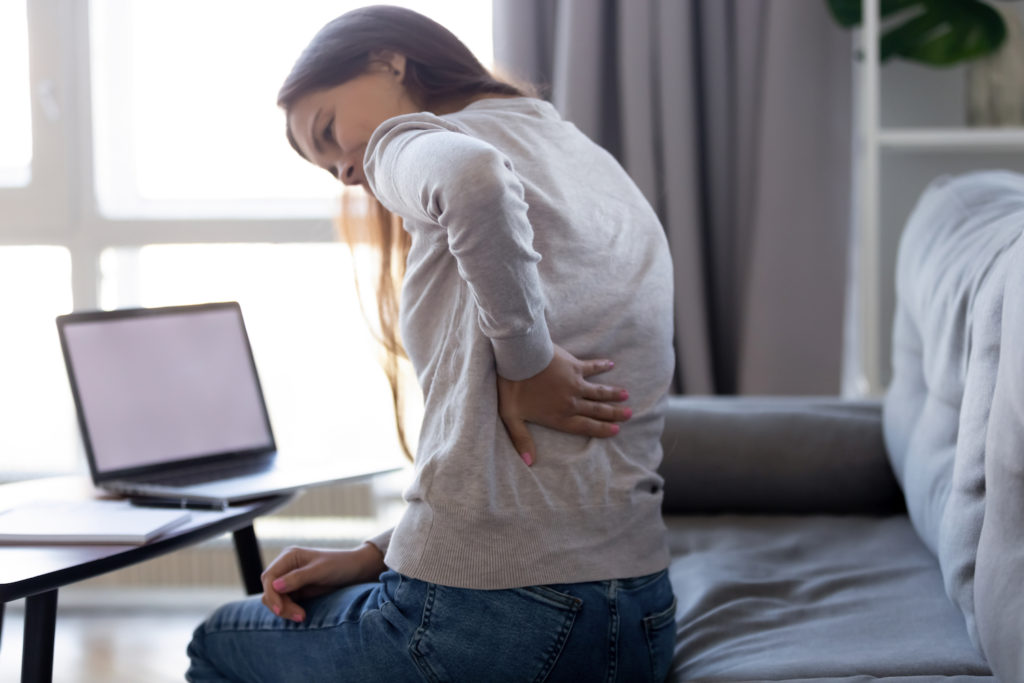 a woman suffering from a back pain